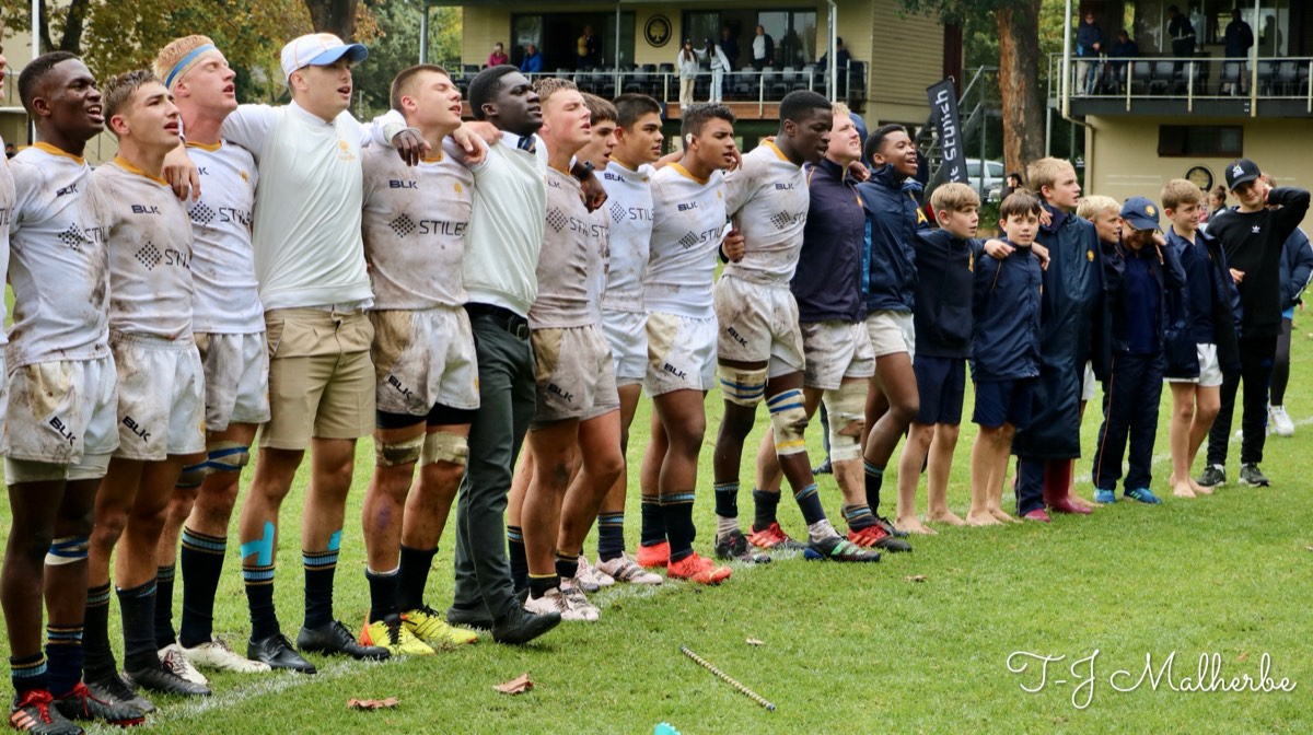 The Rondebosch team and young supporters singing together after a match