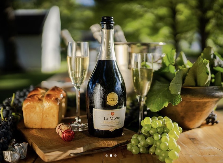 A Franschhoek wine-country table set for guests, with the valley beyond