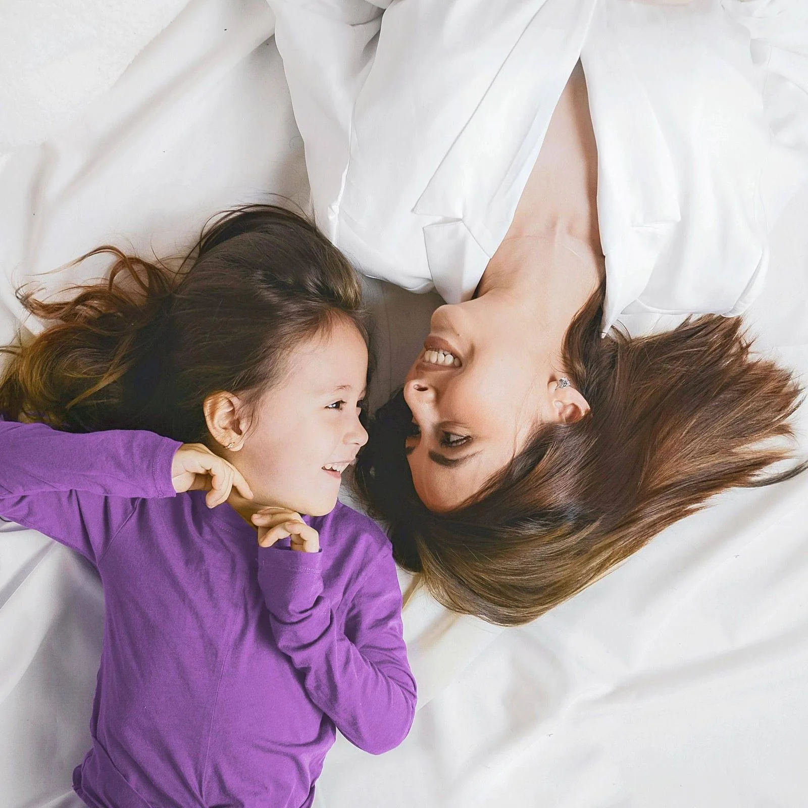 Mother and daughter enjoying clean bedding - CleanMyBed residential service