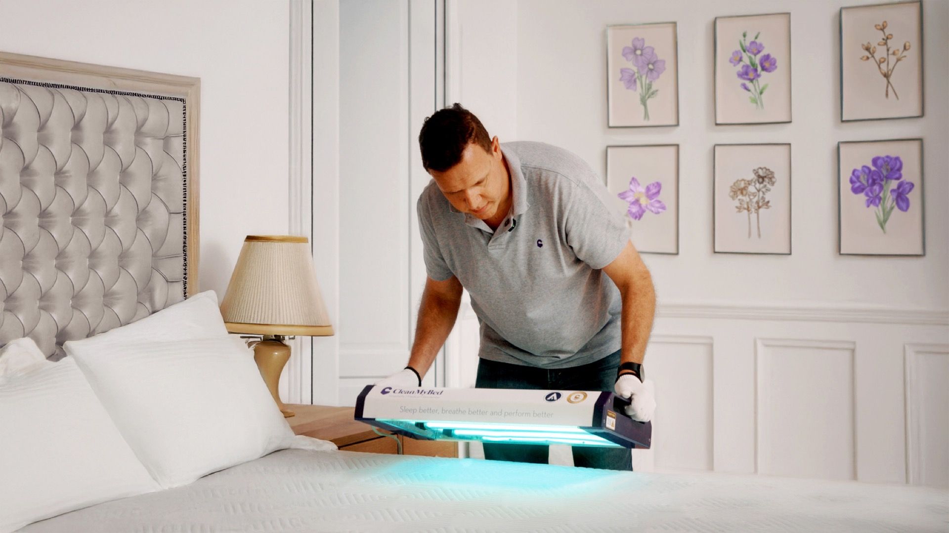 CleanMyBed operator using UV sanitisation device