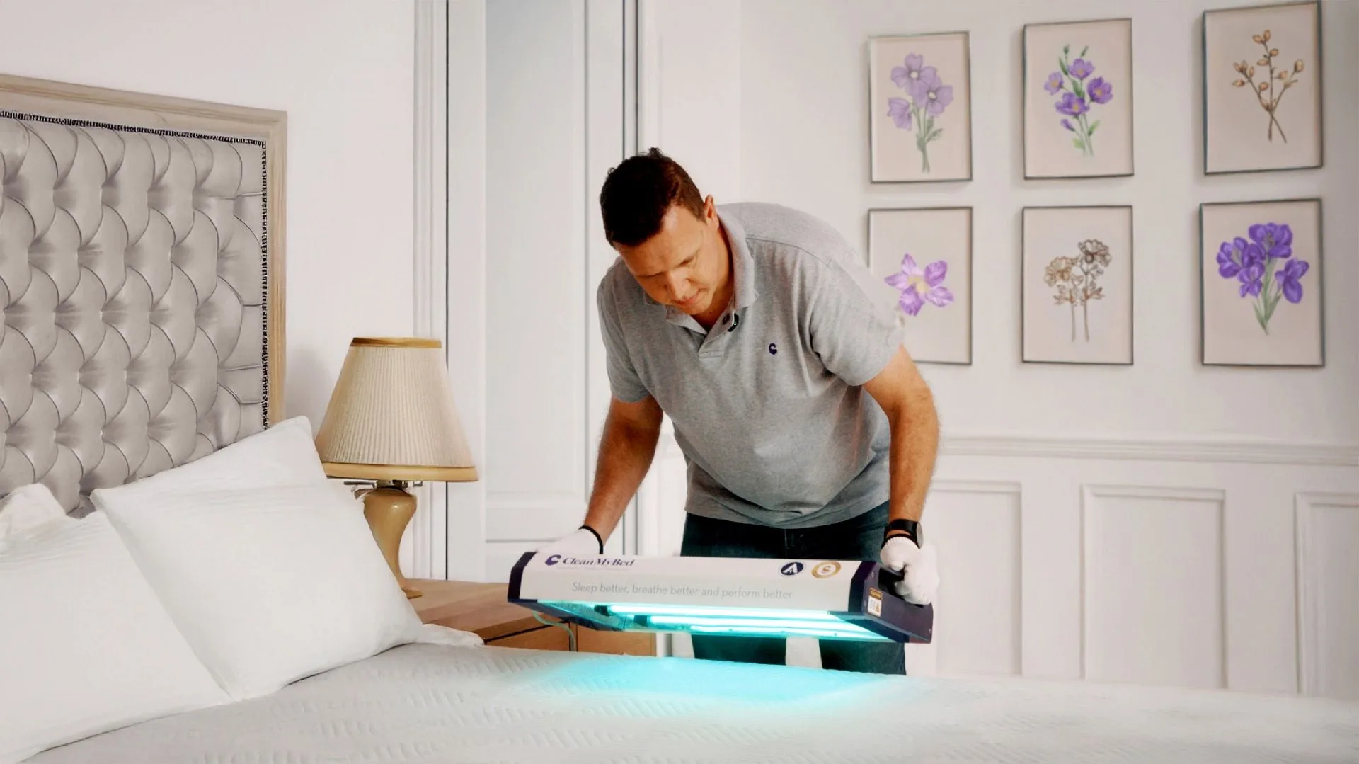 CleanMyBed operator using UV sanitisation device